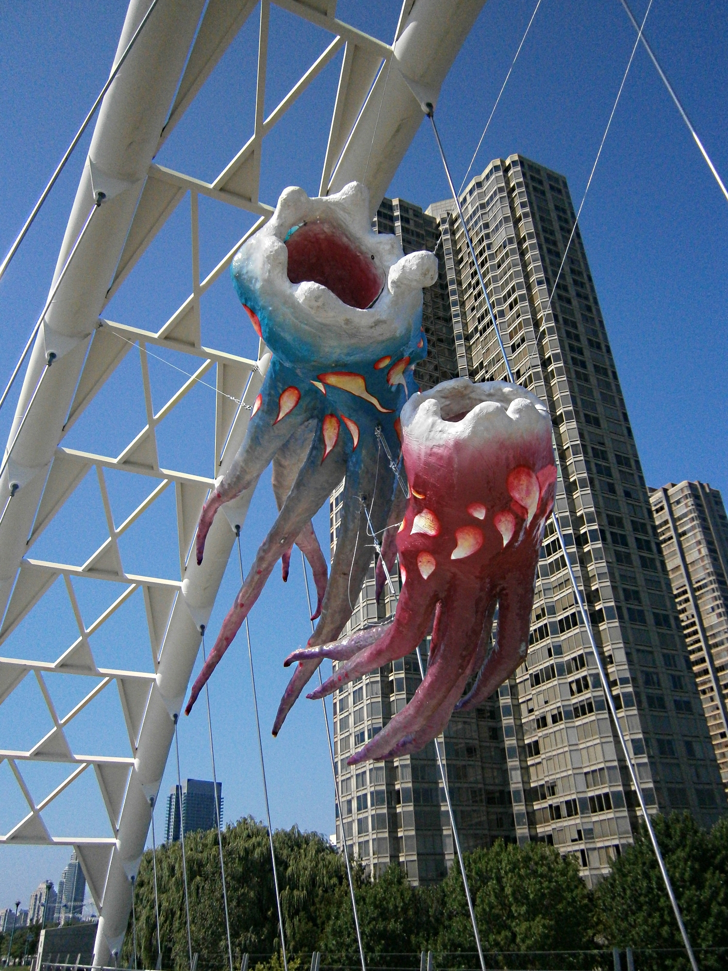 A couple of colourful flying squid sculptures suspended from Humber Bay Bridge in Toronto